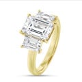 4.40 carat trilogy ring in yellow gold with lab grown emerald cut diamonds