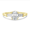2.00 carat trilogy ring in yellow gold with lab grown oval diamond and lab grown tapered baguettes