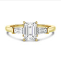 3.00 carat trilogy ring in yellow gold with a lab grown emerald cut diamond and lab gown tapered baguettes