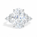 Bespoke ring with an oval diamond and round cluster side stones