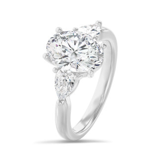 Bague trilogie en or blanc avec un diamant ovale de 3.00 carats et deux diamants en forme de poire de 0.35 carat chacun.